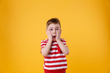 Wall Mural - Surprised little kid with hands on his face