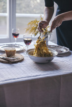 Woman Serving Tagliatelle Pasta With Black Truffle From The Vintage Bowl