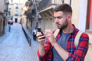 Man using GPS on his cell phone to find the right way 