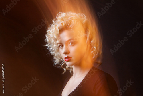 Portrait Of A Attractive Woman With Blonde Curly Hair In Mixed