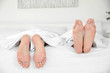 © Africa Studio - Feet of young cute couple together in bed