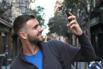 Wall Mural - Man snapping a selfie for social media