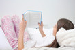© Africa Studio - Young woman reading book on bed at home