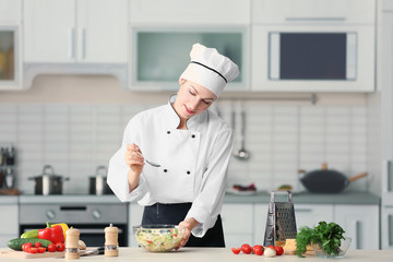 Sticker - Female chef adding oil to vegetable salad in kitchen