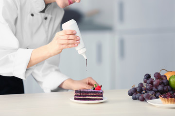 Sticker - Female chef decorating cake in kitchen