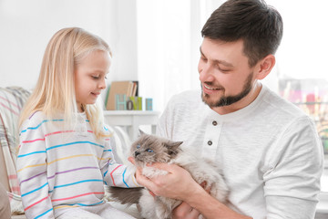 Canvas Print - Father and his daughter with cat at home