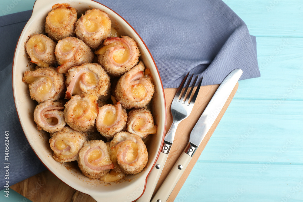 Crockpot with delicious chicken cordon bleu on wooden board