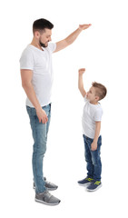 Wall Mural - Handsome man with his son on white background