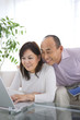 © amanaimages - Mature couple using laptop