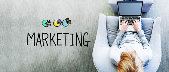 Wall Mural - marketing text with man using a laptop