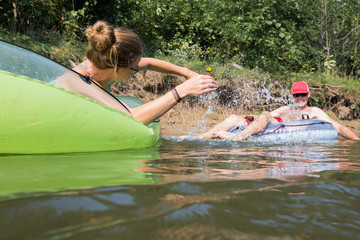 Couple tubing down the river in the summer