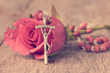Silver Crucifix And Single Rose