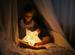 A girl is holding a  nightlight in the form of a star and is sitting on the bed
