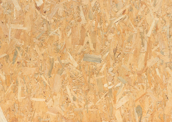 pressed wooden panel background, seamless texture of oriented strand board - OSB wood