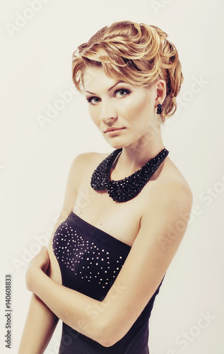 Beautiful Blonde Woman In Elegant Black Low Cut Back Evening Dress
