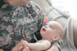 © Africa Studio - Military father holding his newborn baby