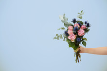 Female Hand Holding Beautiful Bouquet On Light Background
