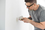 Fototapeta  - Man working on electrical outlet