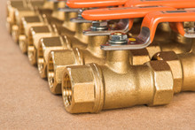 Brass Valves On The Wooden Board Background.valves Used For In The Plumbing System.
