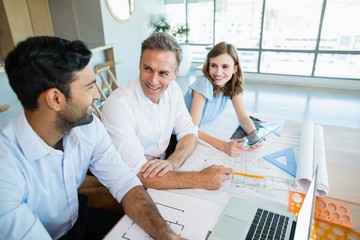 Wall Mural - Architects discussing with each other in conference room