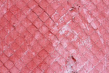 Old red concrete wall with steel mesh as a background or texture