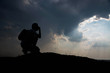 © stcom - Silhouette of man sitting and sky with sunlight