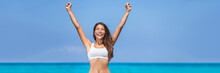 Happy Success Woman Winner. Asian Girl Cheering Arms Up Of Fitness Challenge Achievement On Summer Blue Ocean Beach Background.