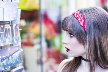 Portrait of a beautiful woman  in the street window shopping