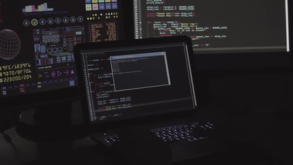 IT Programmer write code program on the laptop in dark room