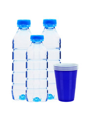 Wall Mural - Blue bottles with water and plastic cups isolated on white