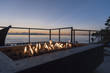 Gas lit backyard fire pit on the beach house outdoor patio at sunset