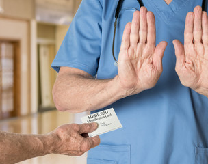 Senior doctor in scrubs refusing Medicaid Card