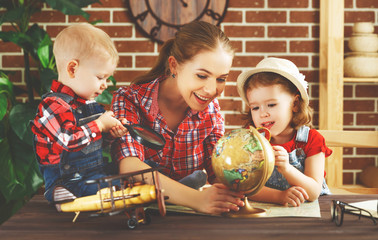 Wall Mural - Happy family of mother and children prepare to  travel trip, learn for route map