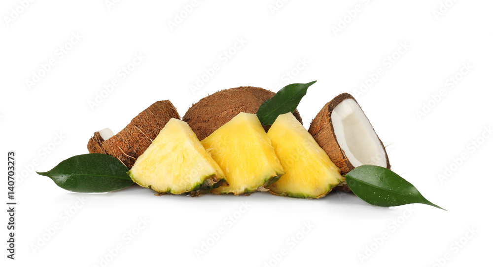 Composition of pineapple slices and coconuts on white background