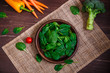 © tanyastock - Spinach leaves in bowl. Carrot, pepper and cherry tomatoes, brocoli. Raw fresh vegetable. Fresh natural plant leaf. Organic food on wooden table.