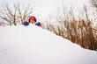 © RooM The Agency - Boy playing on top of a pile of snow