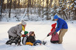 © RooM The Agency - Family playing in the snow with a sledge
