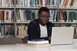 © Jale Ibrak - Happy African Male Student With Laptop In Library