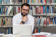 © Jale Ibrak - Young Student Using His Laptop In A Library