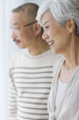 © amanaimages - Mature couple smiling and looking away