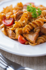 Wall Mural - tasty pasta Fusilli with sausage for meal