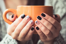 Woman With Beautiful Manicure Holding A Orange Cup Of Cocoa