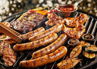 Wall Mural - Assorted meat and vegetables on a summer BBQ