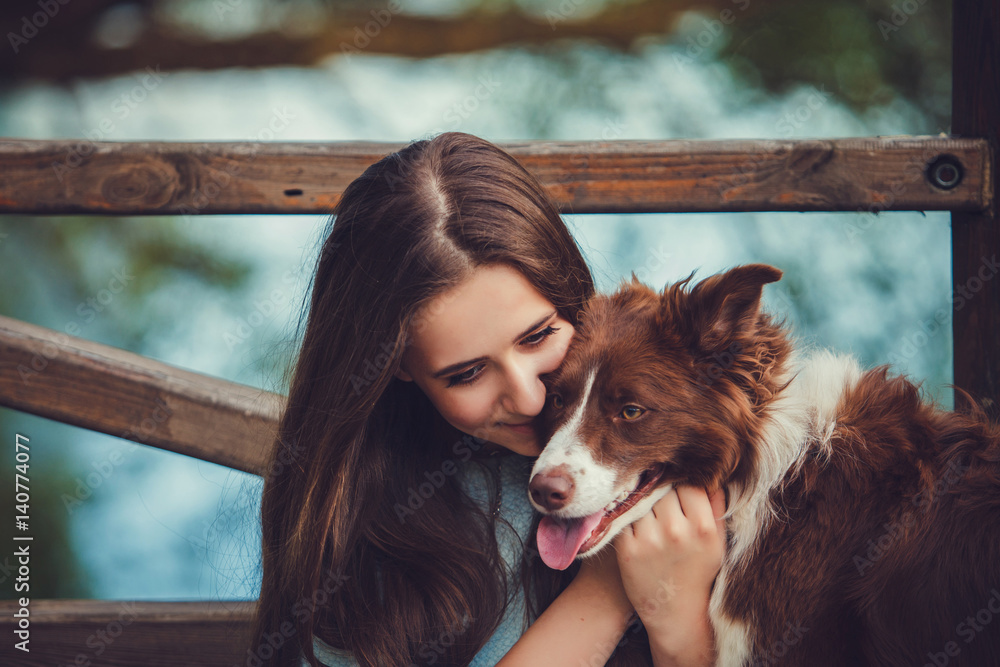 Portrait of a woman with her border collie dog outdoors - obrazy, fototapety, plakaty 