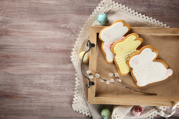 Wall Mural - Creative rabbit shape Easter cookies on wooden tray