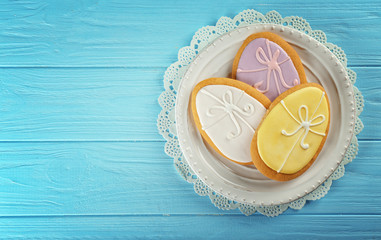 Wall Mural - Beautiful glazed Easter cookies on wooden table