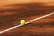 © Westend61 - Tennis ball hitting the line on clay court