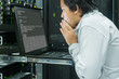 © Pixza - System administrator serious working in data center
