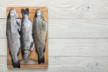 Wall Mural - Raw trout on a wooden background