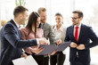 © BGStock72 - View at business partners analyze the business results in modern office